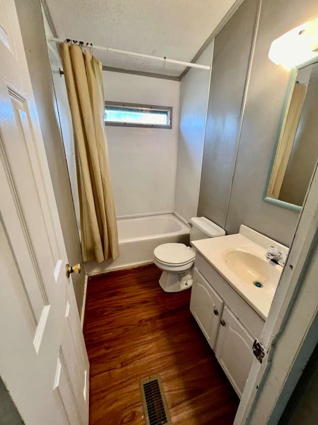 full bathroom featuring vanity, toilet, shower / bath combination with curtain, and hardwood / wood-style floors