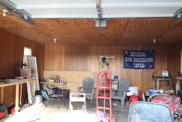 garage featuring wood walls and a garage door opener