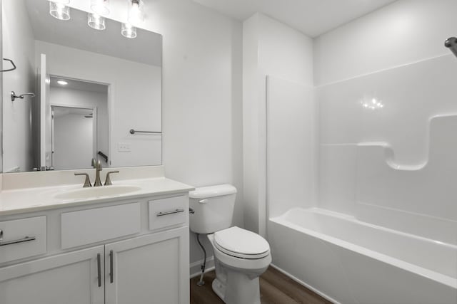 full bathroom with vanity, wood-type flooring, bathtub / shower combination, and toilet