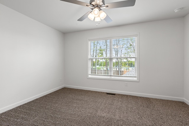 unfurnished room with ceiling fan, carpet floors, and a wealth of natural light