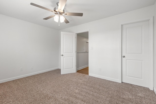 unfurnished bedroom featuring ceiling fan and carpet