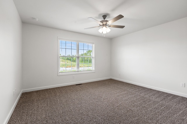 carpeted spare room featuring ceiling fan