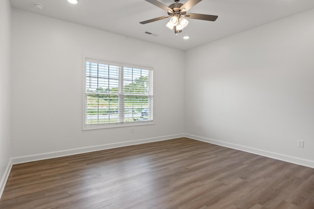 spare room featuring ceiling fan and dark wood-type flooring