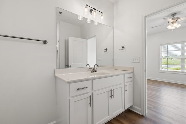 bathroom with vanity, hardwood / wood-style flooring, and ceiling fan