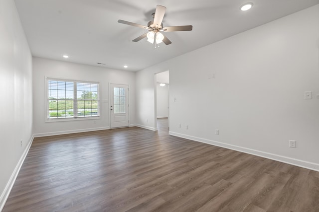 unfurnished room with dark hardwood / wood-style flooring and ceiling fan