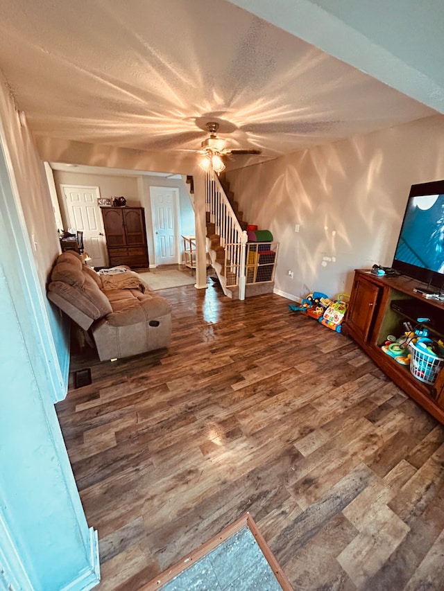 unfurnished living room with ceiling fan and wood-type flooring