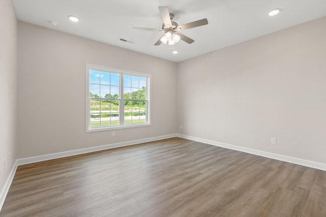 spare room featuring ceiling fan and hardwood / wood-style floors