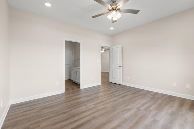 unfurnished bedroom with ceiling fan, light hardwood / wood-style floors, and ensuite bath