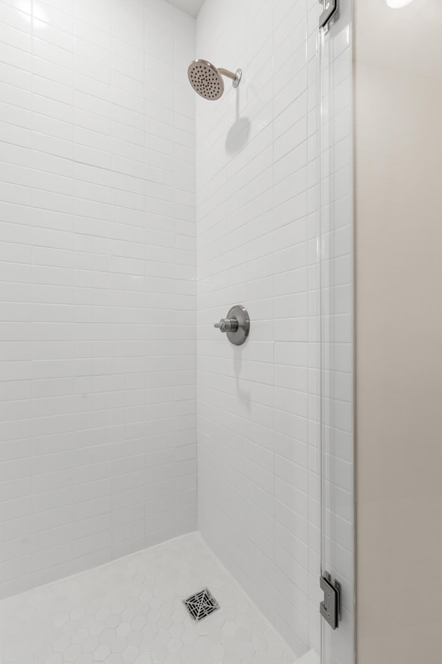 bathroom with a shower with door