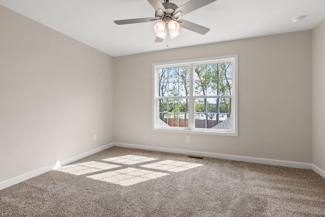 carpeted spare room with ceiling fan