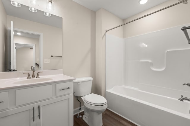 full bathroom featuring hardwood / wood-style floors, toilet, vanity, and shower / washtub combination