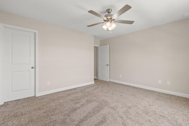 spare room featuring carpet floors and ceiling fan