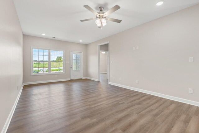 spare room with hardwood / wood-style floors and ceiling fan