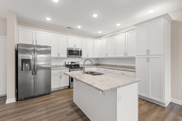 kitchen with sink, light stone countertops, white cabinetry, and stainless steel appliances