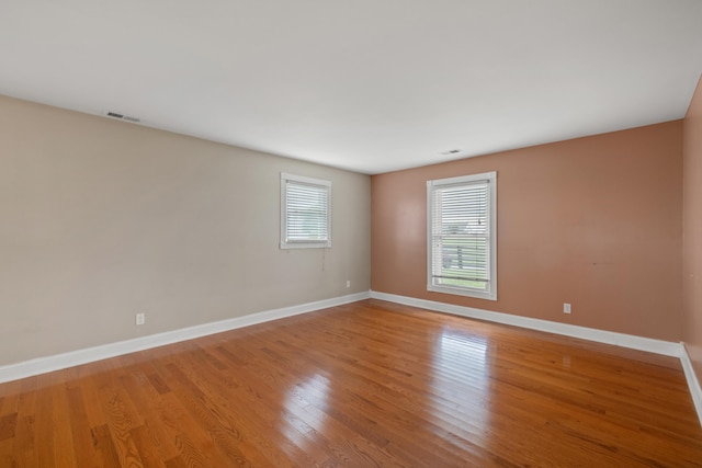 unfurnished room with light hardwood / wood-style flooring