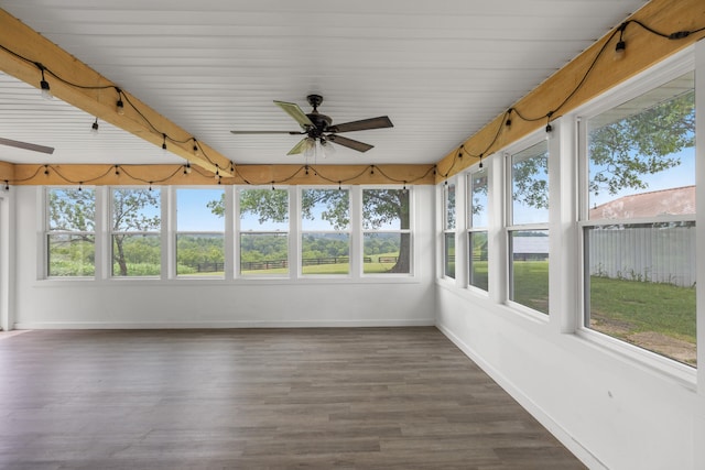 unfurnished sunroom featuring ceiling fan