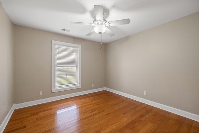 spare room featuring hardwood / wood-style flooring and ceiling fan