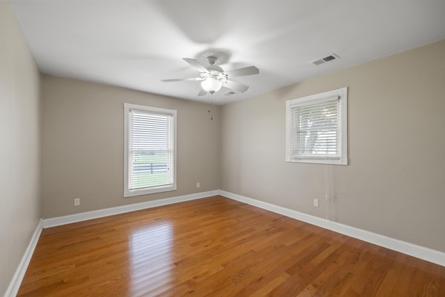 spare room with ceiling fan and hardwood / wood-style floors