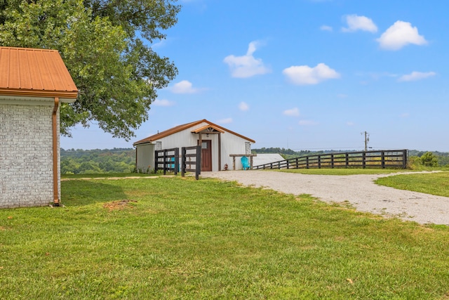 view of yard featuring a rural view and an outdoor structure