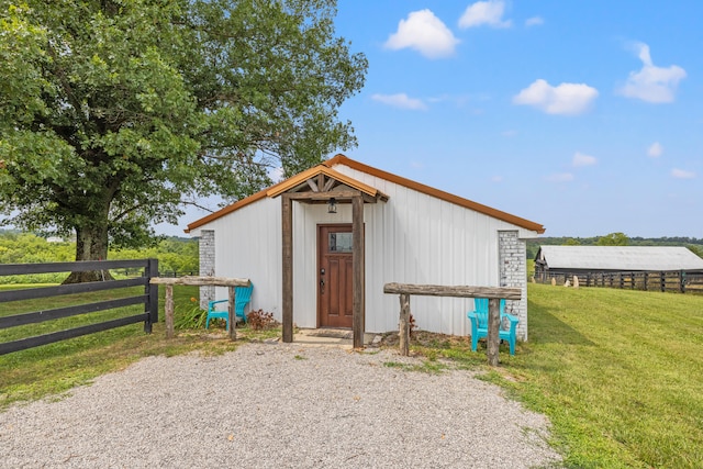 view of outbuilding with a yard