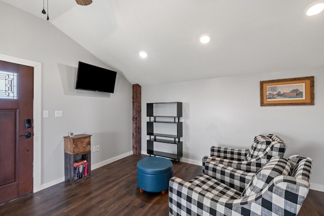 sitting room with dark wood-type flooring and lofted ceiling