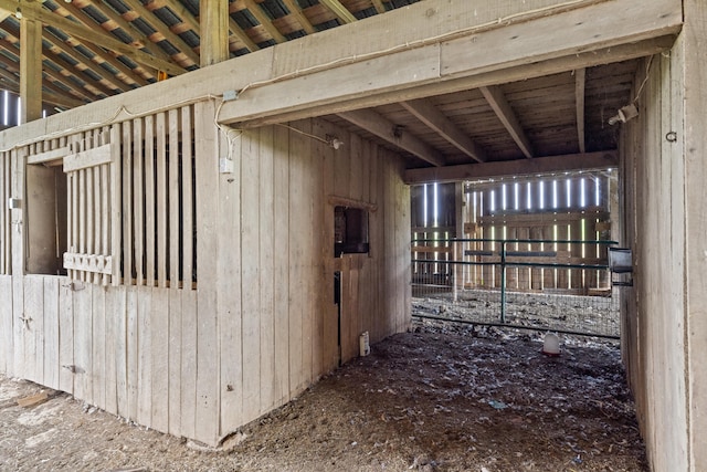 view of horse barn with an outbuilding