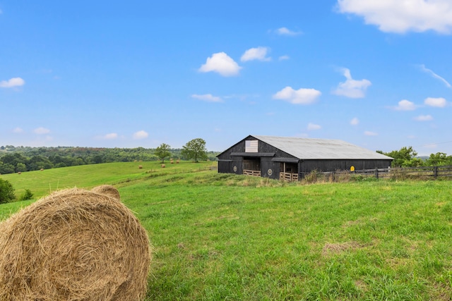 view of yard with a rural view and an outbuilding