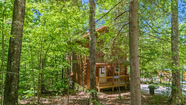 rear view of property with a wooden deck