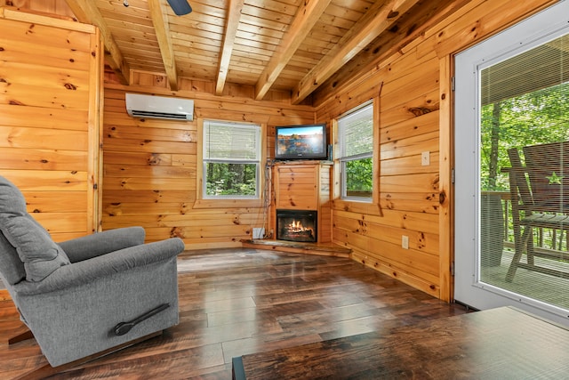 living room featuring hardwood / wood-style floors, a healthy amount of sunlight, beamed ceiling, wooden walls, and a wall mounted AC