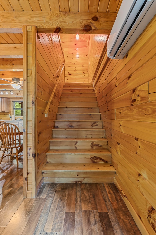 staircase featuring wood ceiling, hardwood / wood-style flooring, and a wall mounted air conditioner