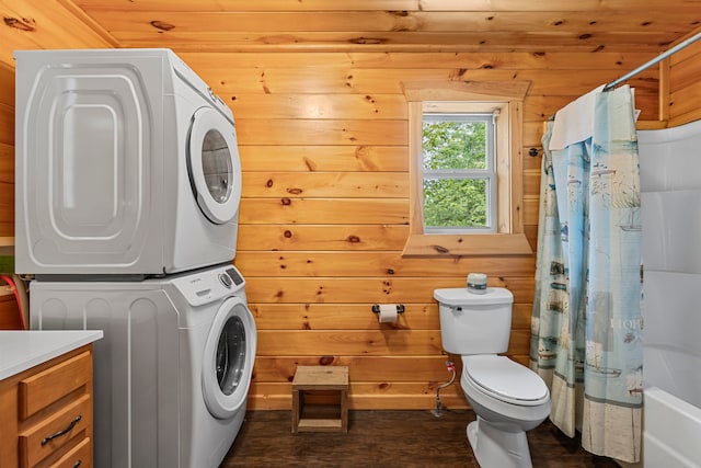 laundry room with wood ceiling, wooden walls, stacked washer and dryer, and dark wood-type flooring