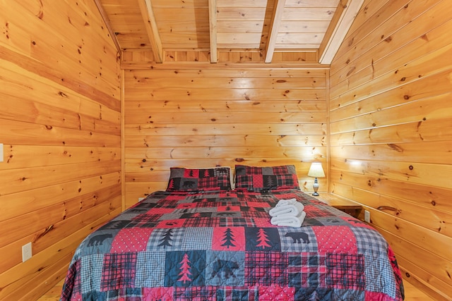 bedroom with wooden walls, wooden ceiling, and beamed ceiling