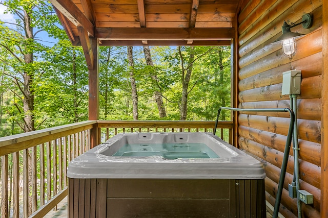 wooden terrace featuring a hot tub