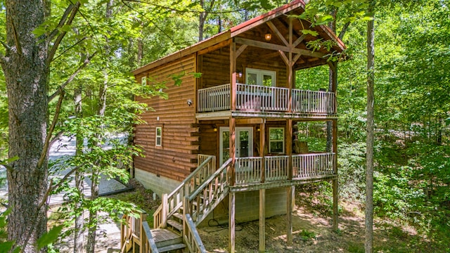 back of house featuring a balcony