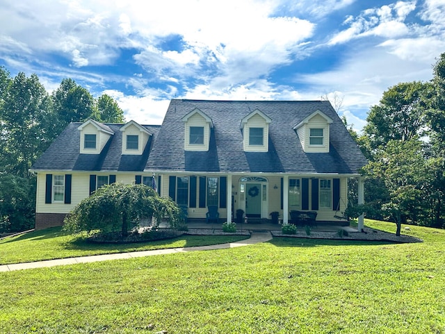 cape cod-style house with a front yard and covered porch