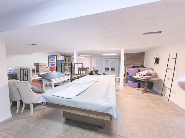 playroom with light tile patterned floors and a textured ceiling