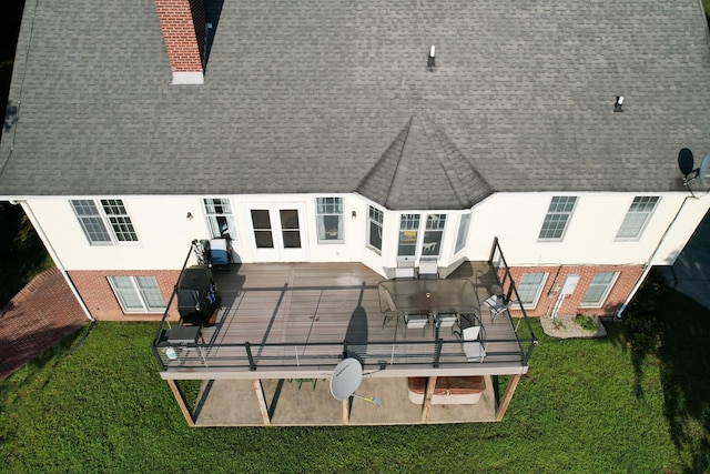 rear view of house with a patio and a lawn