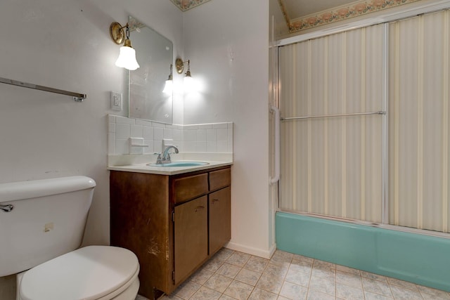 full bathroom with vanity, shower / bath combination with glass door, backsplash, tile patterned floors, and toilet