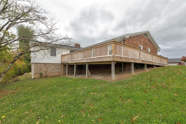 rear view of house with a yard and a deck