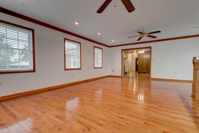 unfurnished room with a wealth of natural light, ceiling fan, light hardwood / wood-style floors, and ornamental molding