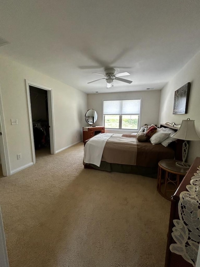 bedroom featuring a ceiling fan, carpet flooring, and baseboards