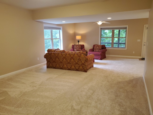 living area with recessed lighting, light colored carpet, and baseboards