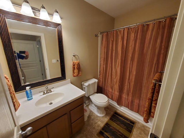 bathroom featuring toilet, shower / tub combo with curtain, vanity, and tile patterned floors