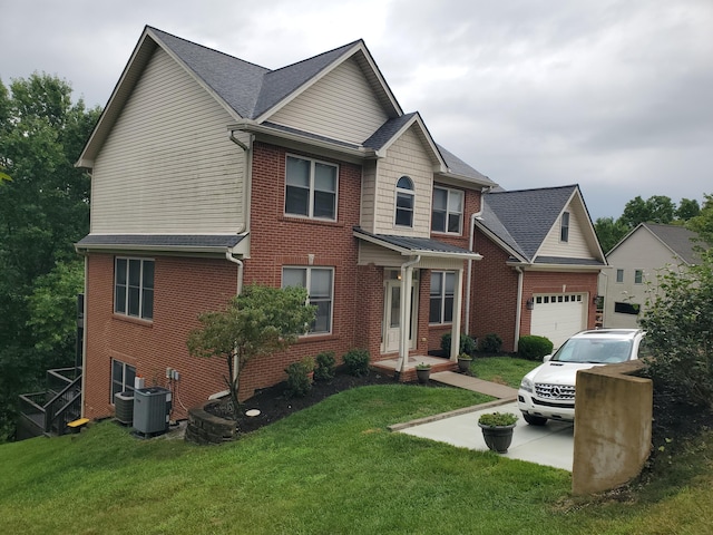 view of front of house with a front lawn, brick siding, an attached garage, and central AC unit