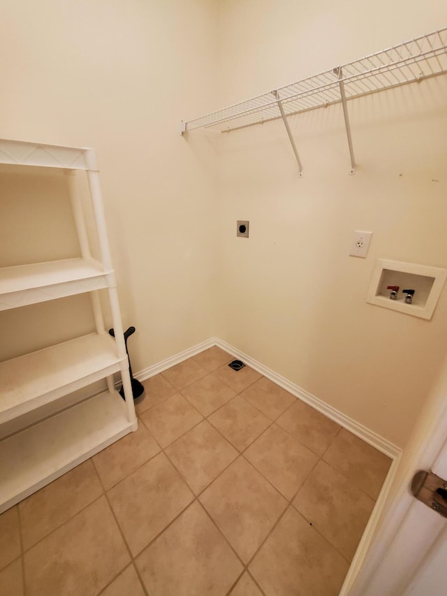 washroom with laundry area, washer hookup, baseboards, tile patterned floors, and electric dryer hookup