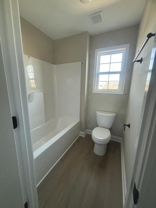 bathroom with hardwood / wood-style floors and toilet