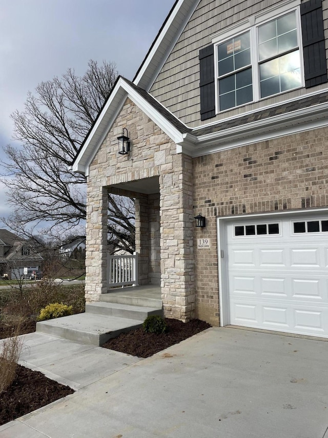 doorway to property with a garage