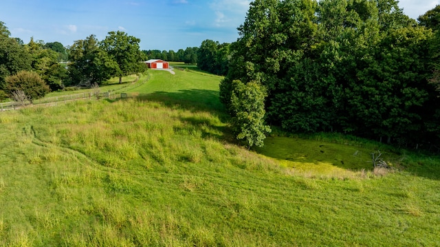 view of yard featuring a rural view and an outdoor structure