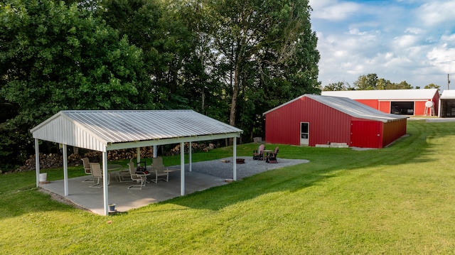 view of yard with an outbuilding and a patio