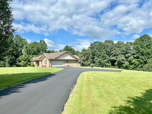 view of front of house featuring a front yard and a garage